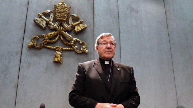 Cardinal George Pell arrives to make a statement at the Vatican on Thursday.