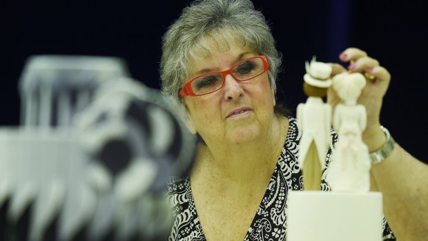 Cake decorating judge Maureen Gunton inspects the novive entries for judging during for The Royal Easter Show. 