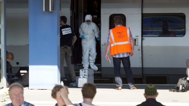 Members of a police forensics team at Arras train station search the Thalys train that was the scene of the attack.