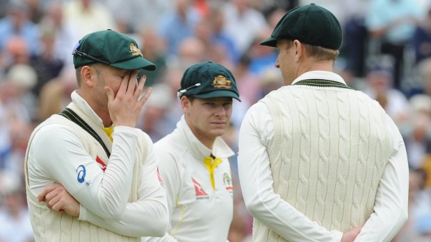 Tough tour: Captain Michael Clarke speaks to Adam Voges, right, and Steve Smith during day two at Trent Bridge.