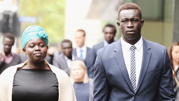 Former North Melbourne player Majak Daw outside the County Court with his sister, Sarah Daw.