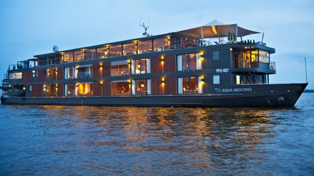 The cruise ship Aqua Mekong idles along the traditional river transport system of Cambodia.