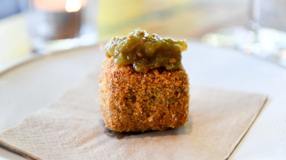 A puck of crumbed and fried terrine crowned with green tomato relish.