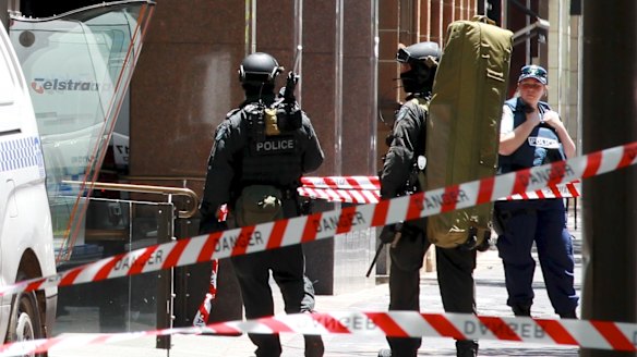 Police snipers enter Martin Place from Macquarie Street as the siege unfolded.