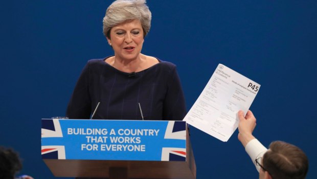 Prankster Simon Brodkin handed British Prime Minister Theresa May a P45 slip, a document used to fire employees.