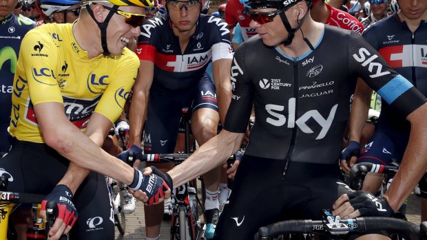 BMC's Australian rider Rohan Dennis shakes hands with Team Sky leader Chris Froome before the start of stage 2 in Utrecht.