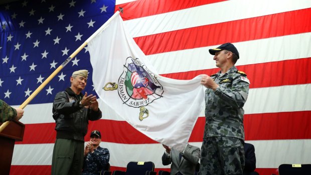 Admiral Harry Harris, Commander, US Pacific Command (left) and Vice Admiral David Johnston, Chief of Joint Operations, unfurl the Talisman Sabre flag at the opening ceremony.