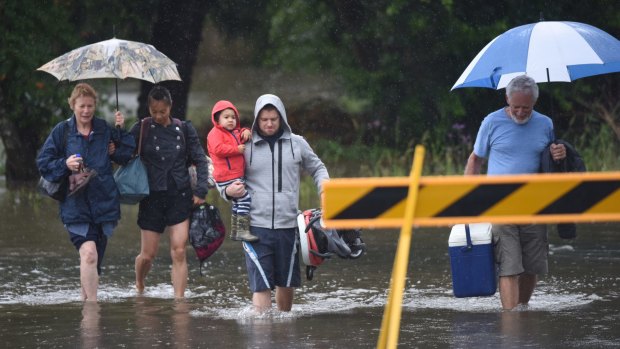 Residents leave their homes near the Hunter River.