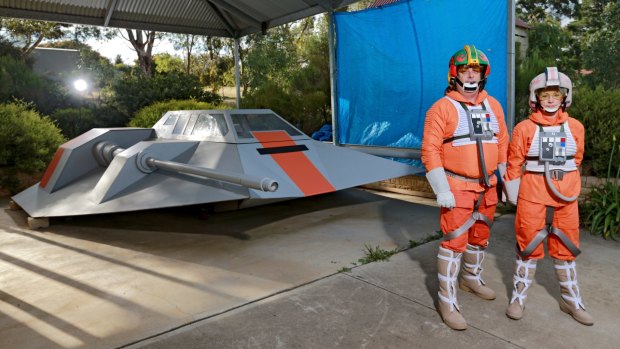<i>Star Wars</i> fans Mark and Nancy Dickson with the full-sized snowspeeder Mark built in his garage in Eden Park, outside Melbourne.