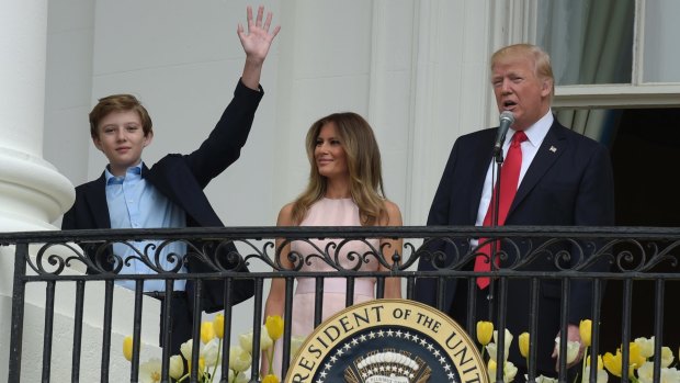 Donald Trump, accompanied by Melania Trump, introduces their son Barron from the Truman Balcony of the White House. 