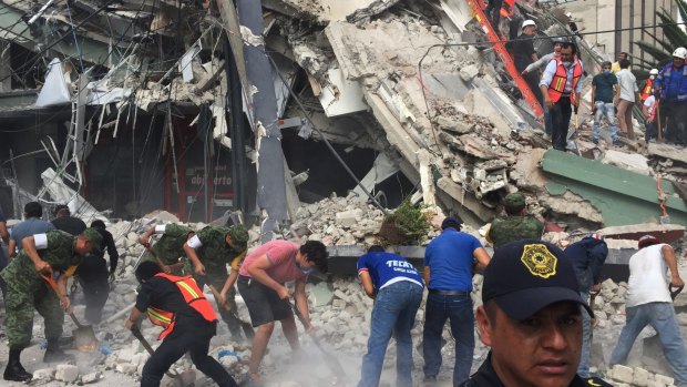 People search for survivors in a collapsed building in the Roma neighborhood of Mexico City.