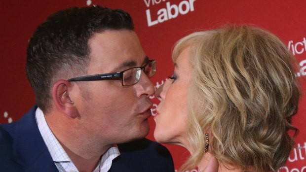 Incoming Victorian Premier Daniel Andrews kisses his ''secret campaign weapon'', wife Cath after his victory speech.