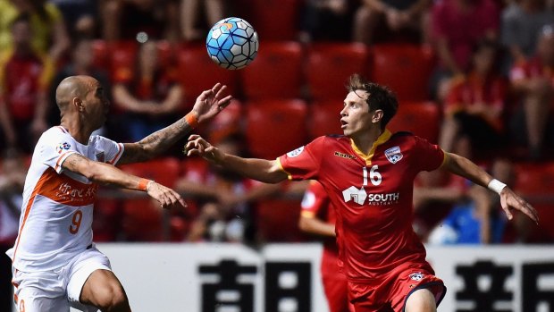 There it is: Shandong's Diego Tardelli and Adelaide United midfielder Craig Goodwin battle for possession on Tuesday night.