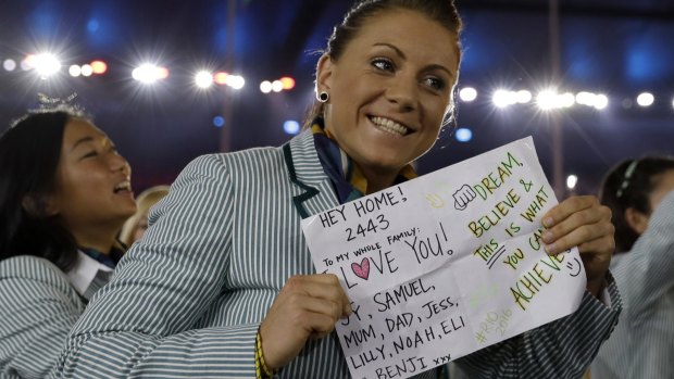 An Australian athlete holds up a sign as the Australia team arrive during the opening ceremony for the 2016 Summer Olympics in Rio de Janeiro, Brazil.