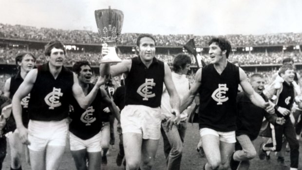 Carlton captain John Nicholls holds the 1970 premiership cup aloft.