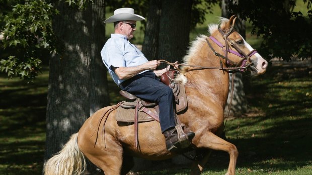 Former Alabama Chief Justice and US Senate candidate Roy Moore rides in on a horse in Gallant, Alabama. 