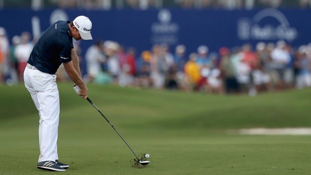 Tight finish: Justin Rose of England tees off on the 18th hole.