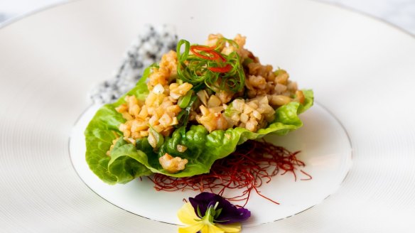 Sang choy bao – a single leaf of cos lettuce topped with diced southern rock lobster.