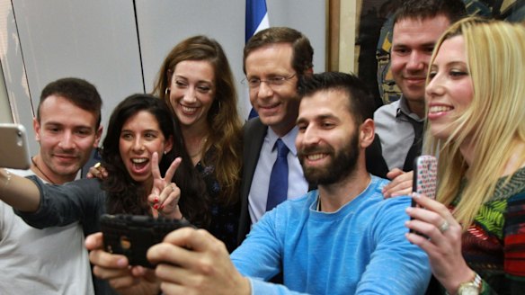 Zionist Union leader Isaac Herzog, centre, poses for a photo with voters in Tel Aviv. 