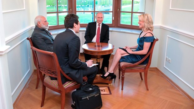 NBC journalist Megyn Kelly, right, smiles as she interviews India's Prime Minister Narendra Modi, left, and Russian President Vladimir Putin, centre, in St Petersburg.