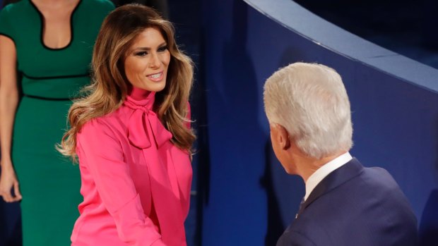 Melania Trump, in a Gucci pussy bow blouse, greets Bill Clinton at the second presidential debate.