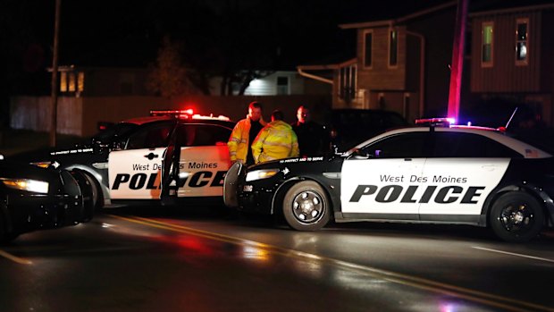 Officers investigate the scene of one of the police shootings in Des Moines.