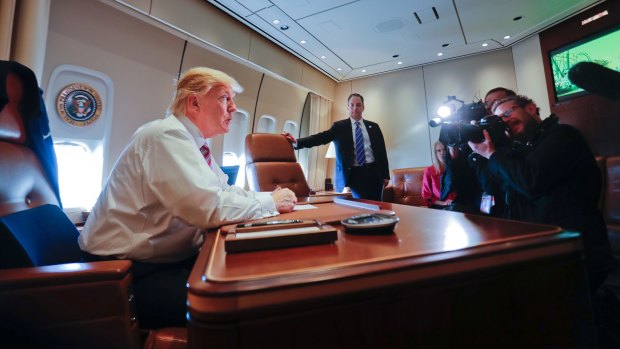 President Donald Trump at his desk on Air Force One on Thursday.