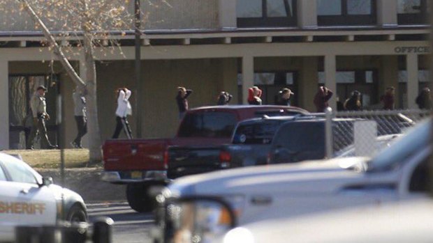 Students are led out of Aztec High School after a shooting in Aztec, New Mexico.