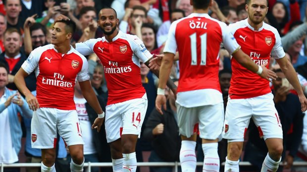 Arsenal's Alexis Sanchez celebrates scoring their third goal with team mates.