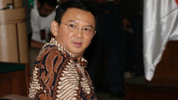 Jakarta governor Ahok sits on the defendant's chair at the start of his trial.