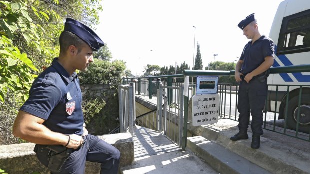 French policemen secure the closed stairway to a tunnel leading to La Mirandole beach.