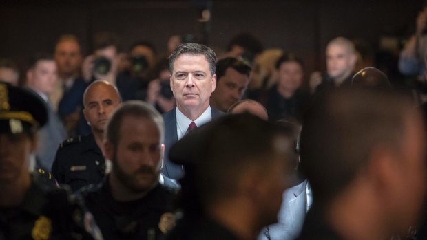 Former FBI director James Comey walks through a corridor on the way to a secure room to continue his testimony to the Senate Select Committee on Intelligence.