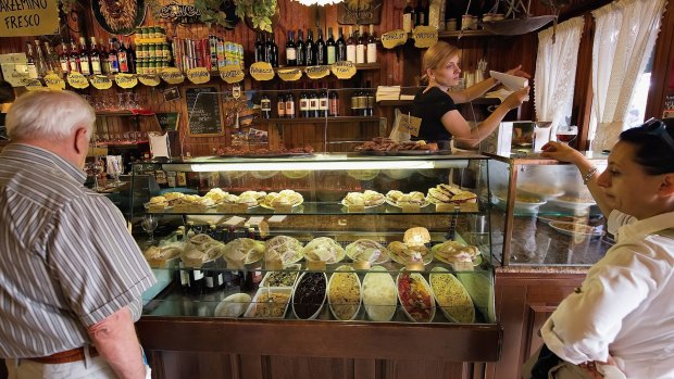 Customers wait for their cicchetti at a traditional bacaro in Venice, Italy. The bacari, open just for lunch and dinner, are the local down to earth version of wine bars. 