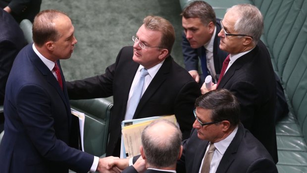 Immigration minister Peter Dutton being congratulated by his Coalition colleagues after he introduced the Australian Citizenship Amendment Bill.
