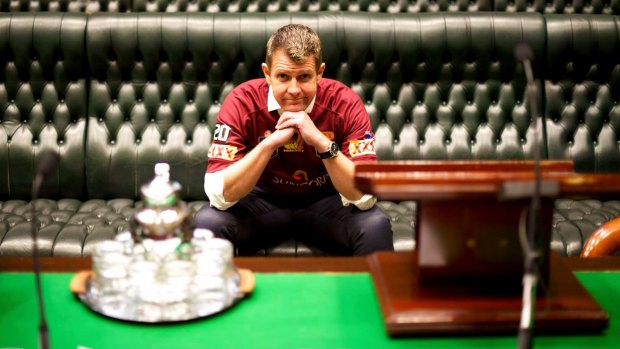 Premier Mike Baird completes his wager with Queensland Premier Annastacia Palaszczuk by wearing a Maroons jersey in question time on Tuesday.