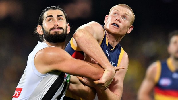 Tight call: Brodie Grundy of the Magpies and Crow Sam Jacobs.