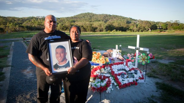 Too young: Peni and Lisa Fotuaika, parents of NRL player Mosese, pictured at the Brisbane cemetery where he was buried.