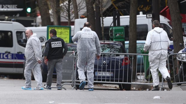 Police enter the Bataclan theatre where dozens were killed.