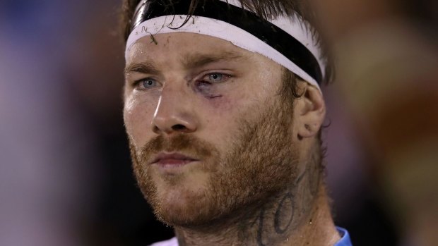 'Half English, half tattooed': Chris McQueen watches on from the bench during the Titans' match against the Sharks.