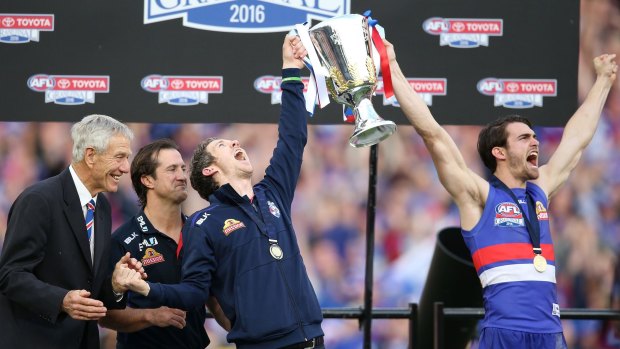 Luke Beveridge, Robert Murphy and Easton Wood of the Bulldogs celebrate the moment.