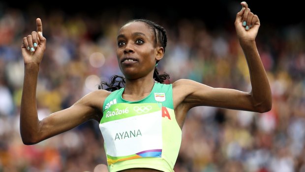Almaz Ayana of Ethiopia crosses the finish line.