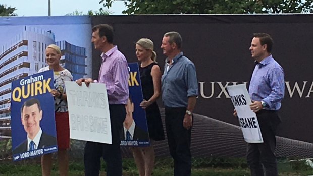 Lord Mayor Graham Quirk with some of his successful LNP team thank motorists at Kangaroo Point after being re-elected.