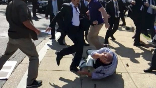 In this frame grab from video provided by Voice of America, members of Turkish President Recep Tayyip Erdogan's security detail are shown violently reacting to peaceful protesters during Erdogan's trip last month to Washington. 
