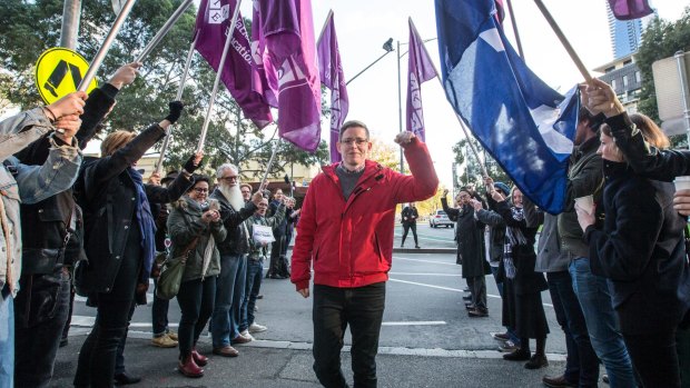 Roz Ward gives a clenched fist salute after returning to work at La Trobe University following controversy earlier this year.