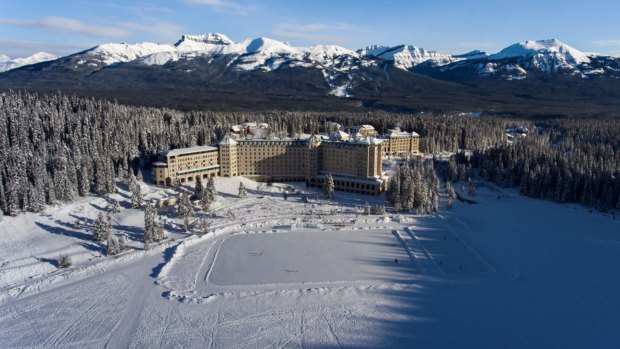 The impressive Fairmont Chateau Lake Louise on the edge of the lake, with skating rink created on the lake.