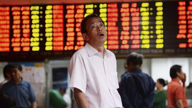 A man looks at stock market prices in disbelief at a brokerage house in Shanghai. Expect to see more images like these.
