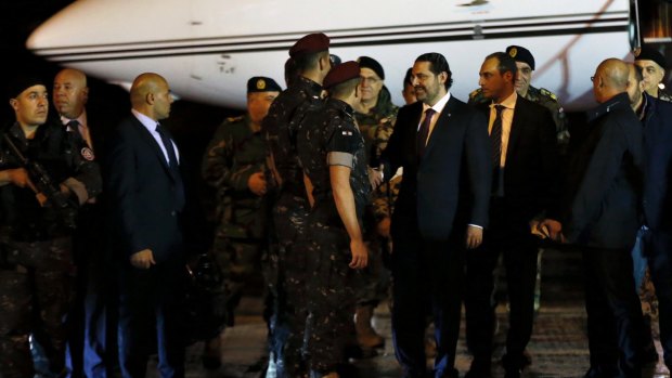 Lebanese Prime Minister Saad Hariri, center, escorted by his bodyguards upon arrival at the Rafik Hariri International Airport in Beirut.