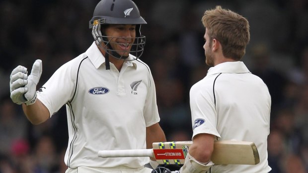 Happy hunting: Kane Williamson is congratulated by Ross Taylor after the milestone came up.
