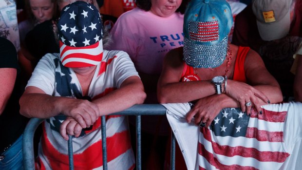 Red, white and blue: Supporters of Republican presidential candidate Donald Trump pray during a campaign rally in Panama City, Florida.
