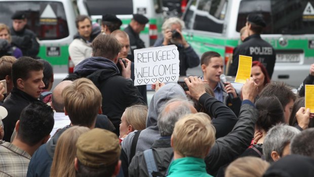 Syrian refugees are welcomed on arrival in Munich.